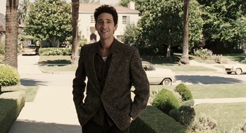 Movie still from “Hollywoodland” (2006), directed by Allen Coulter – A man standing in front of bushes and trees; Medium shot, Over the shoulder angle