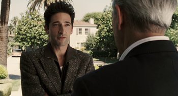 Movie still from “Hollywoodland” (2006), directed by Allen Coulter – A man wearing a suit and tie talking to another man; Medium shot, Over the shoulder angle