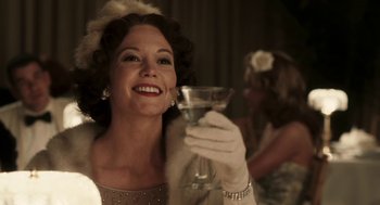Movie still from “Hollywoodland” (2006), directed by Allen Coulter – A woman holding a glass of wine in her hand; Close Up shot, Over the shoulder angle