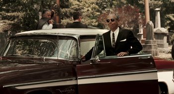 Movie still from “Hollywoodland” (2006), directed by Allen Coulter – A man sitting in the driver's seat of an old car; Medium shot, Over the shoulder angle