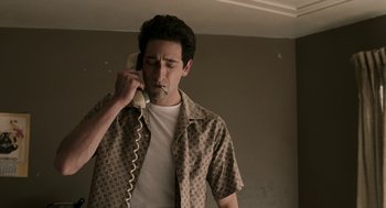 Movie still from “Hollywoodland” (2006), directed by Allen Coulter – A man holding a phone up to his ear; Medium shot, Low angle
