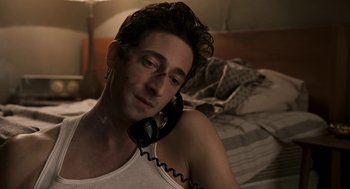 Movie still from “Hollywoodland” (2006), directed by Allen Coulter – A man is talking on the phone while lying in bed; Close Up shot, High angle