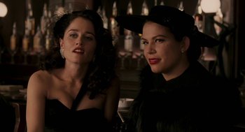 Movie still from “Hollywoodland” (2006), directed by Allen Coulter – Two beautiful women in black outfits posing for a picture; Close Up shot, Over the shoulder angle
