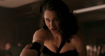 Movie still from “Hollywoodland” (2006), directed by Allen Coulter – A beautiful woman holding a sword in a dark room; Close Up shot, Over the shoulder angle