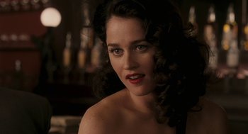 Movie still from “Hollywoodland” (2006), directed by Allen Coulter – A beautiful woman with long black curly hair and red lipstick; Close Up shot, Over the shoulder angle