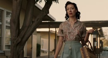 Movie still from “Hollywoodland” (2006), directed by Allen Coulter – A woman standing in front of a tree outside; Medium shot, Low angle