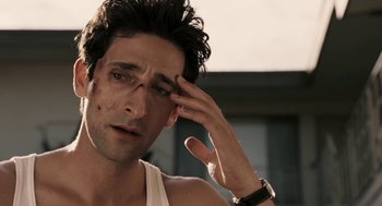 Movie still from “Hollywoodland” (2006), directed by Allen Coulter – A person holding his hand up to his forehead; Close Up shot, High angle