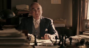 Movie still from “Hollywoodland” (2006), directed by Allen Coulter – An older man sitting in front of a chess board; Medium shot, Over the shoulder angle