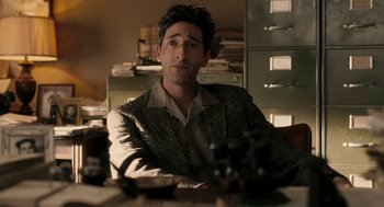 Movie still from “Hollywoodland” (2006), directed by Allen Coulter – A man sitting at a table in a room; Medium shot, High angle