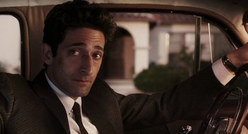 Movie still from “Hollywoodland” (2006), directed by Allen Coulter – A person wearing a suit and tie; Close Up shot, Over the shoulder angle