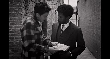 Two young men are standing in the alley