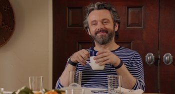 A man sitting at a table with a cup in his hand