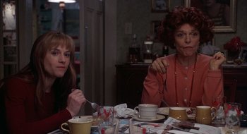 Movie still from “Home for the Holidays” (1995), directed by Jodie Foster – Two people sitting at a table with a plate of food; Medium shot, Over the shoulder angle