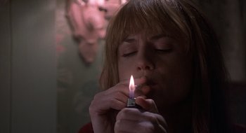 Movie still from “Home for the Holidays” (1995), directed by Jodie Foster – A woman lighting a candle in the dark; Close Up shot, High angle