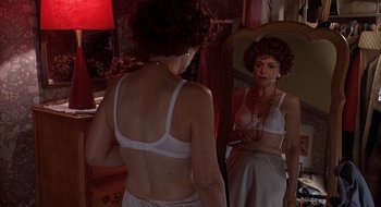 Movie still from “Home for the Holidays” (1995), directed by Jodie Foster – A woman in a bra looking in the mirror; Medium shot, Over the shoulder angle