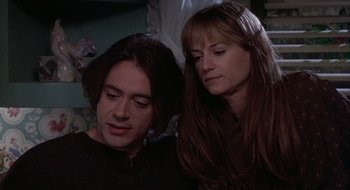 Movie still from “Home for the Holidays” (1995), directed by Jodie Foster – A man and a woman sitting next to each other; Close Up shot, Over the shoulder angle