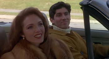 Movie still from “Home for the Holidays” (1995), directed by Jodie Foster – A man and a woman sitting in the back of a car; Close Up shot, Over the shoulder angle