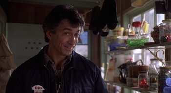 Movie still from “Home for the Holidays” (1995), directed by Jodie Foster – A person in a room near a shelf; Close Up shot, Low angle