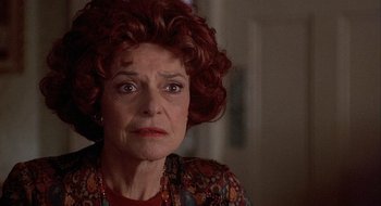 Movie still from “Home for the Holidays” (1995), directed by Jodie Foster – An older woman with red curly hair looking at the camera; Close Up shot, Low angle