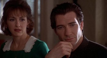 Movie still from “Home for the Holidays” (1995), directed by Jodie Foster – A man and a woman sitting next to each other in a room; Close Up shot, Over the shoulder angle