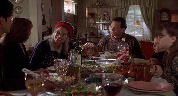 Movie still from “Home for the Holidays” (1995), directed by Jodie Foster – A man and a woman sitting at a dinner table; Medium shot, High angle