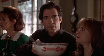 Movie still from “Home for the Holidays” (1995), directed by Jodie Foster – A man holding a bowl of food in his hands; Close Up shot, Over the shoulder angle