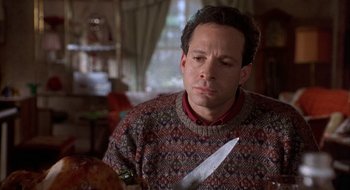 Movie still from “Home for the Holidays” (1995), directed by Jodie Foster – A man holding a knife in his hand; Close Up shot, High angle