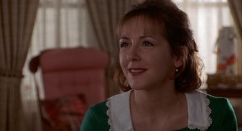 Movie still from “Home for the Holidays” (1995), directed by Jodie Foster – A person sitting in a room; Close Up shot, Over the shoulder angle