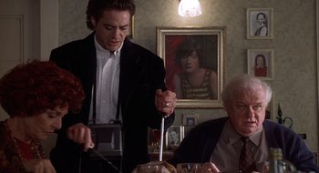Movie still from “Home for the Holidays” (1995), directed by Jodie Foster – A group of people sitting around a table; Medium shot, Over the shoulder angle