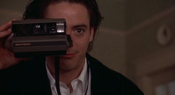 Movie still from “Home for the Holidays” (1995), directed by Jodie Foster – A young man looking through a video camera's lens; Close Up shot, Over the shoulder angle