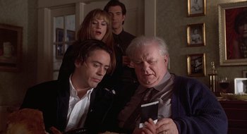 Movie still from “Home for the Holidays” (1995), directed by Jodie Foster – A group of people standing around a table; Close Up shot, High angle