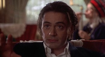 Movie still from “Home for the Holidays” (1995), directed by Jodie Foster – A person wearing a suit and tie; Close Up shot, Over the shoulder angle