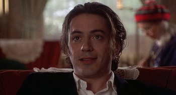 Movie still from “Home for the Holidays” (1995), directed by Jodie Foster – A person wearing a suit and tie; Close Up shot, Over the shoulder angle