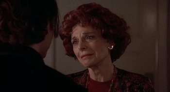 Movie still from “Home for the Holidays” (1995), directed by Jodie Foster – An older woman with red curly hair is crying while talking to a younger woman; Close Up shot, Over the shoulder angle