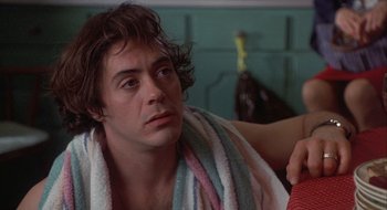 Movie still from “Home for the Holidays” (1995), directed by Jodie Foster – A person with a towel around his neck; Close Up shot, Over the shoulder angle