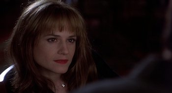 Movie still from “Home for the Holidays” (1995), directed by Jodie Foster – A person wearing a necklace; Close Up shot, Over the shoulder angle