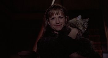 Movie still from “Home for the Holidays” (1995), directed by Jodie Foster – A woman holding a cat in her arms in the dark; Close Up shot, Low angle