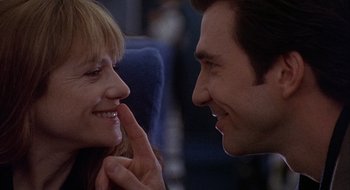 Movie still from “Home for the Holidays” (1995), directed by Jodie Foster – A man and a woman smiling at each other; Close Up shot, Over the shoulder angle