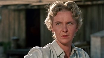 Movie still from “Hondo” (1953), directed by John Farrow – An older woman with blonde curly hair wearing a white shirt; Close Up shot, Low angle