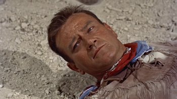 Movie still from “Hondo” (1953), directed by John Farrow – A person with a bandanna around his neck; Close Up shot, High angle