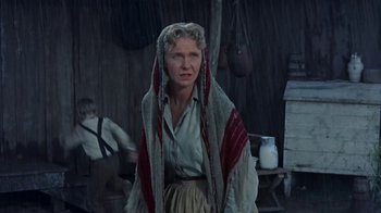 Movie still from “Hondo” (1953), directed by John Farrow – A woman with a long scarf around her neck; Medium shot, Low angle
