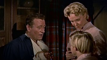 Movie still from “Hondo” (1953), directed by John Farrow – A group of people that are standing up; Medium shot, Low angle