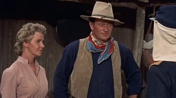 Movie still from “Hondo” (1953), directed by John Farrow – An older man wearing a cowboy hat and vest; Medium shot, Low angle