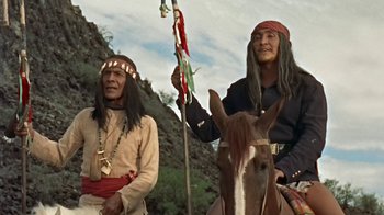 Movie still from “Hondo” (1953), directed by John Farrow – Two native american men on horseback in the mountains; Medium shot, Low angle