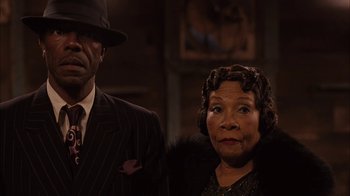 Movie still from “Honeydripper” (2007), directed by John Sayles – An older man and a younger woman standing next to each other; Close Up shot, Low angle