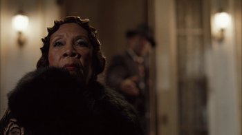 Movie still from “Honeydripper” (2007), directed by John Sayles – An older woman in a fur coat and a man in a suit; Close Up shot, Low angle