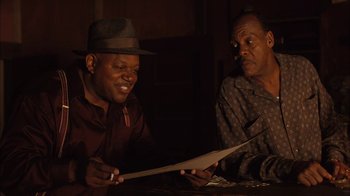 Movie still from “Honeydripper” (2007), directed by John Sayles – Two men sitting at a table looking at a piece of paper; Close Up shot, Over the shoulder angle