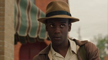 Movie still from “Honeydripper” (2007), directed by John Sayles – A man wearing a brown hat and a brown jacket; Close Up shot, Low angle