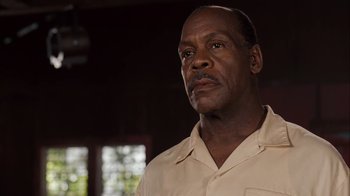 Movie still from “Honeydripper” (2007), directed by John Sayles – An older man wearing a tan shirt looking at the camera; Close Up shot, Low angle