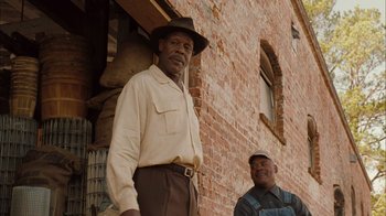 Movie still from “Honeydripper” (2007), directed by John Sayles – Two men standing in front of a brick building; Medium shot, Over the shoulder angle